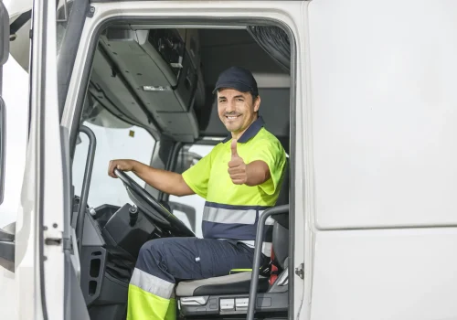 cheerful-male-driver-showing-thumb-up-gesture-whil-2025-03-08-16-34-21-utc