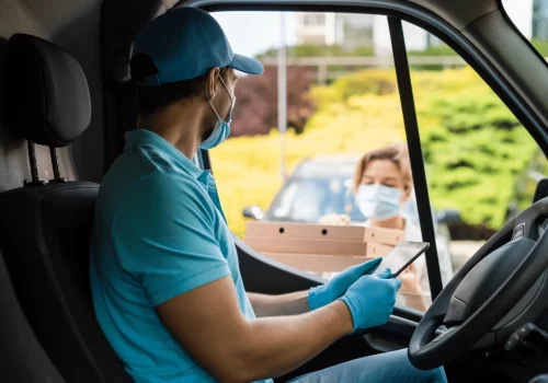 safe-delivery-courier-on-a-van-brings-a-pizza-to-2024-10-15-08-50-56-utc